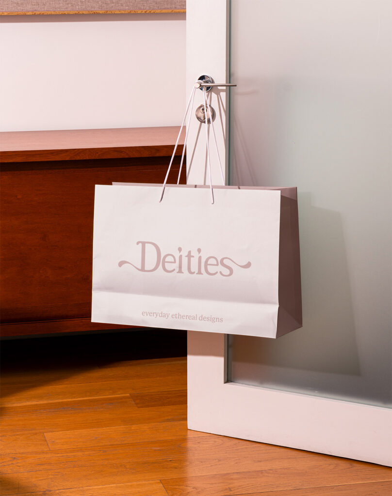 Deities Shopping Bag hanging off a door handle